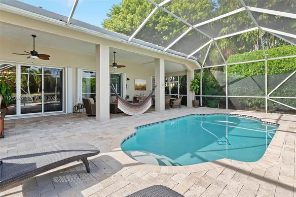 a swimming pool with outdoor seating and yard