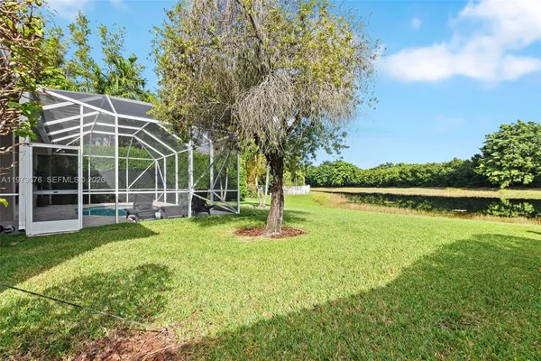 a view of a house with a yard and sitting area