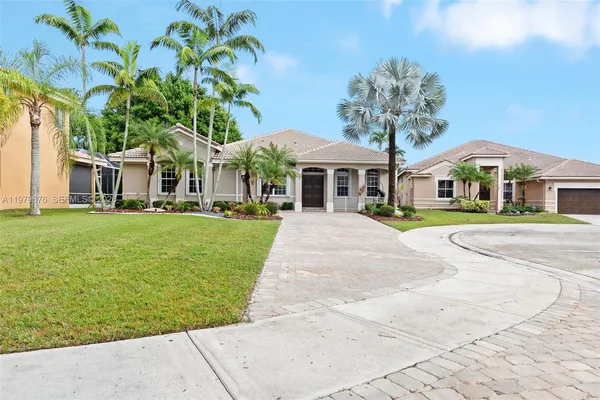 a front view of multiple houses with yard