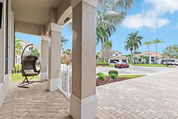 a view of yellow house with a patio