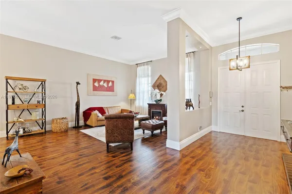 a living room with furniture and wooden floor