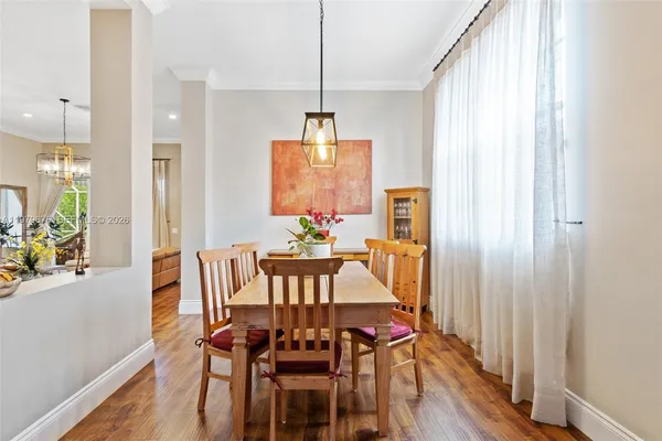 a view of a dining room with furniture window and wooden floor