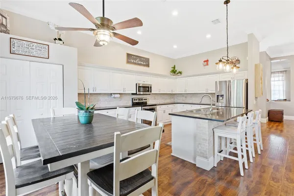 a view of a dining room with furniture and wooden floor