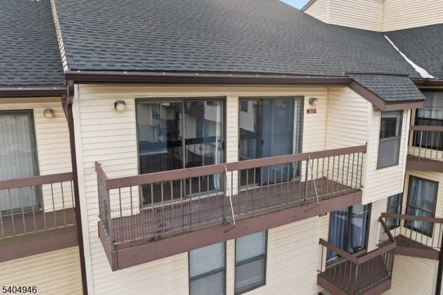 a balcony with table and chairs