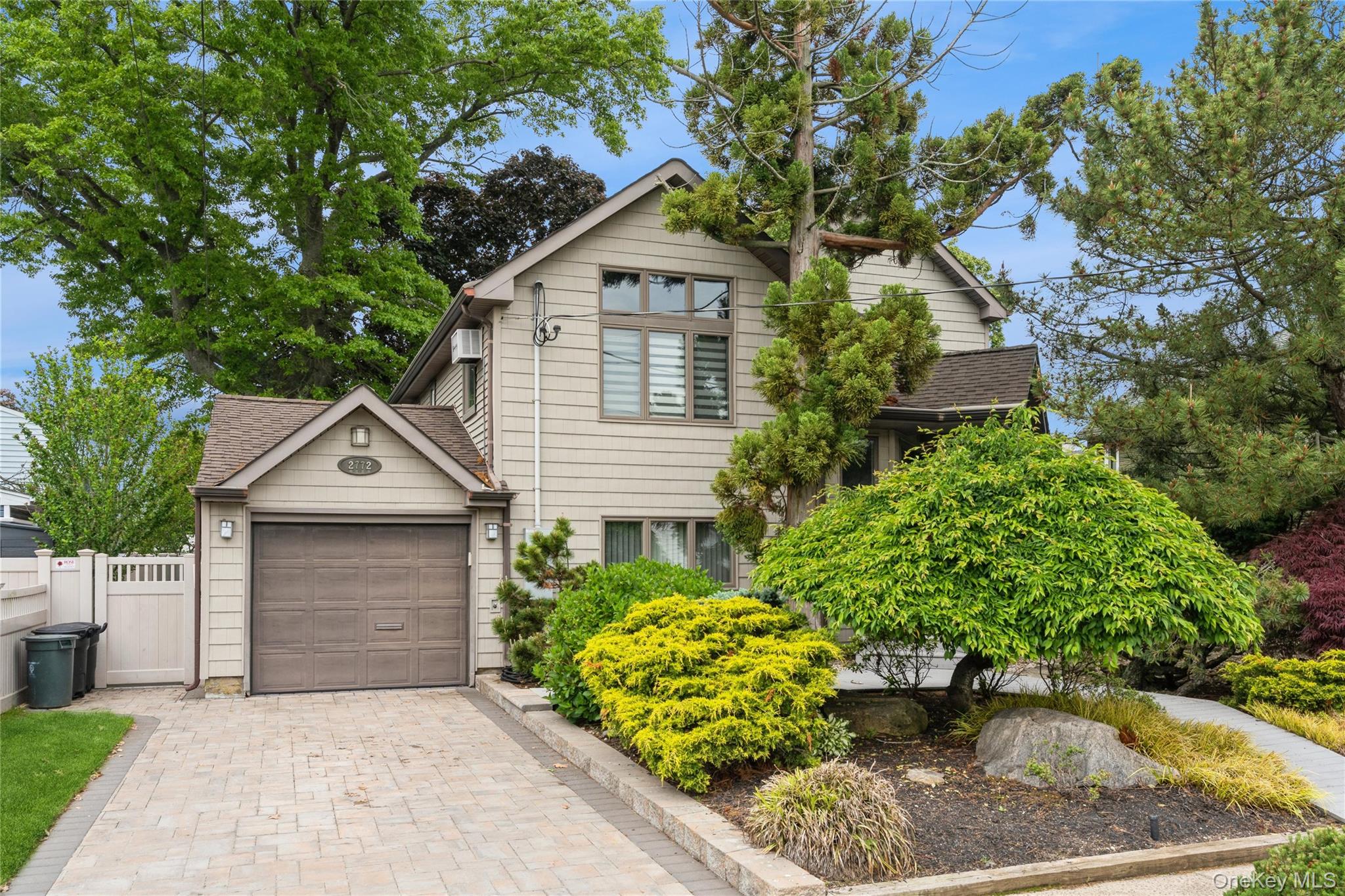 2772 Riverside Avenue Merrick, NY 11566 - Photo 1 of 45 a front view of a house with a garden