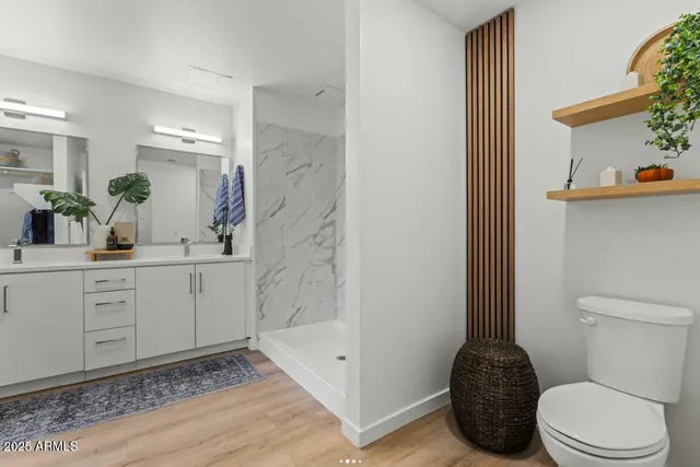 a bathroom with a sink a toilet and shower