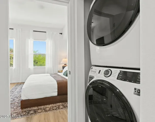 a bedroom with a bed and a painting on the wall