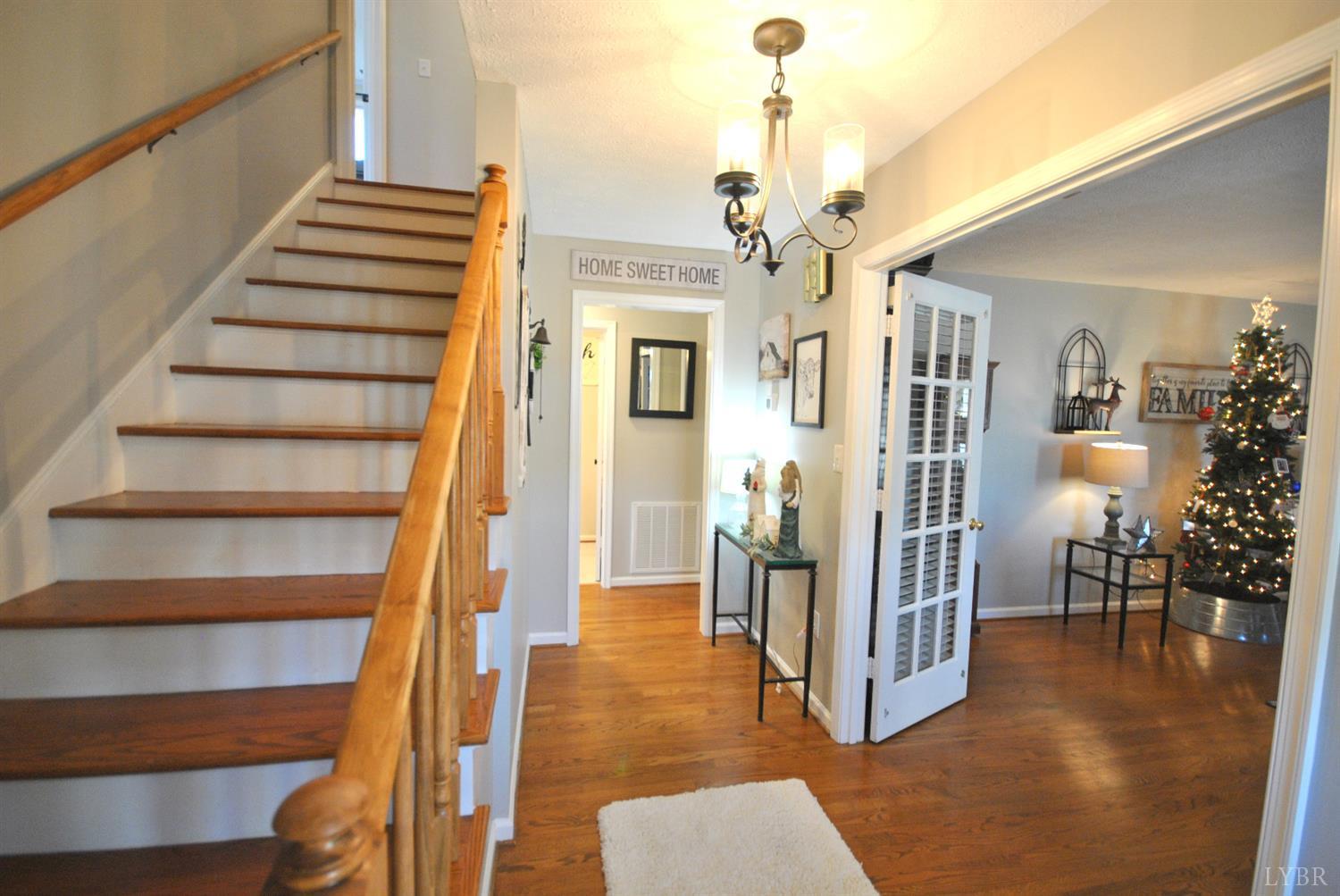 3350 Roaring Run Road Goode, VA 24556 - Photo 12 of 90 a view of a hallway with wooden floor and staircase