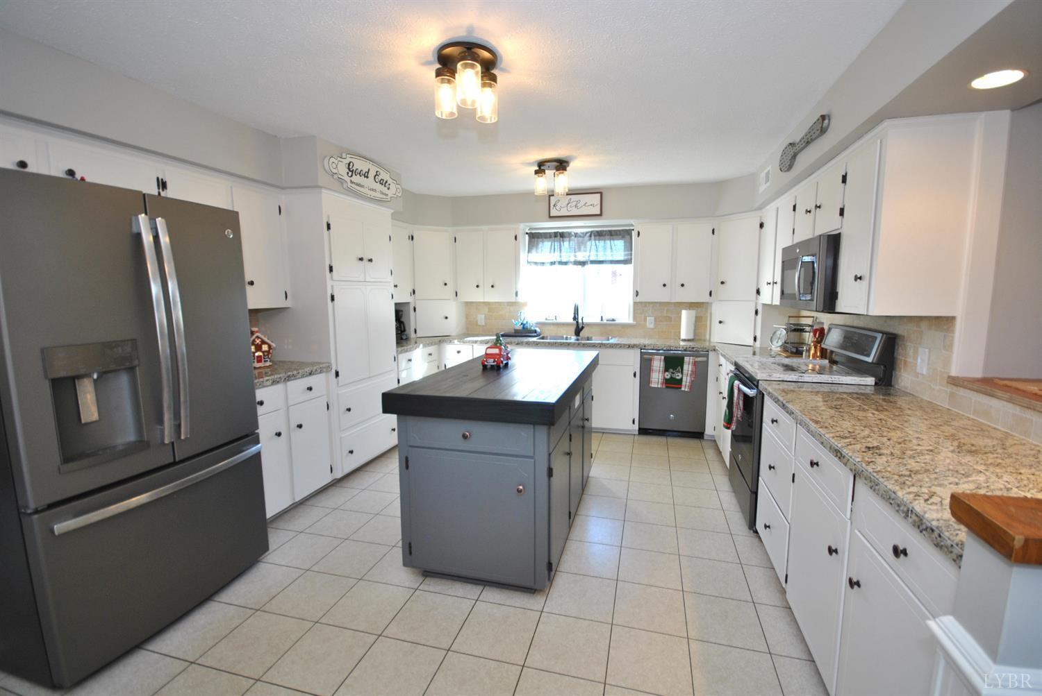 3350 Roaring Run Road Goode, VA 24556 - Photo 24 of 90 a large kitchen with stainless steel appliances lots of counter space and window