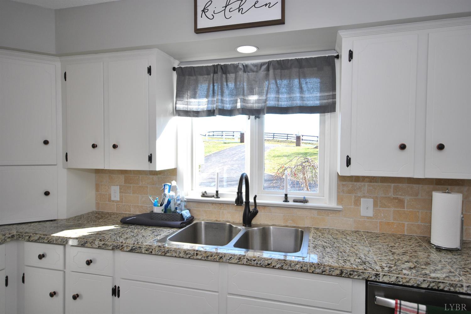 3350 Roaring Run Road Goode, VA 24556 - Photo 27 of 90 a kitchen with granite countertop a sink window and cabinets