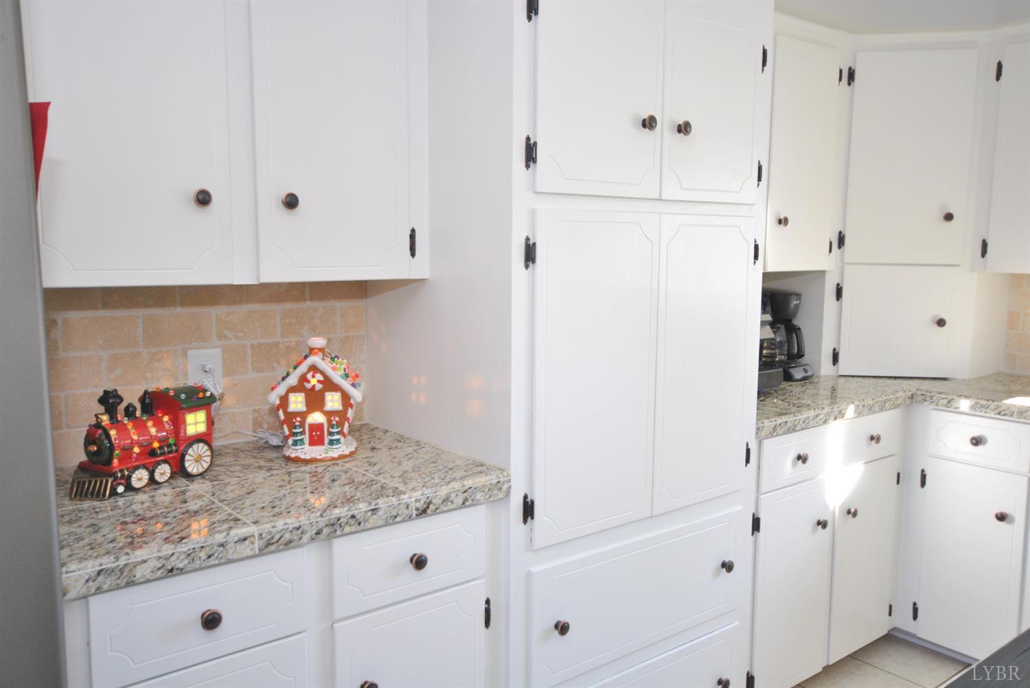 3350 Roaring Run Road Goode, VA 24556 - Photo 28 of 90 a kitchen with granite countertop white cabinets and white appliances