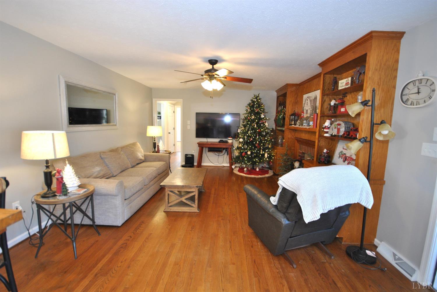 3350 Roaring Run Road Goode, VA 24556 - Photo 33 of 90 a living room with furniture and a flat screen tv