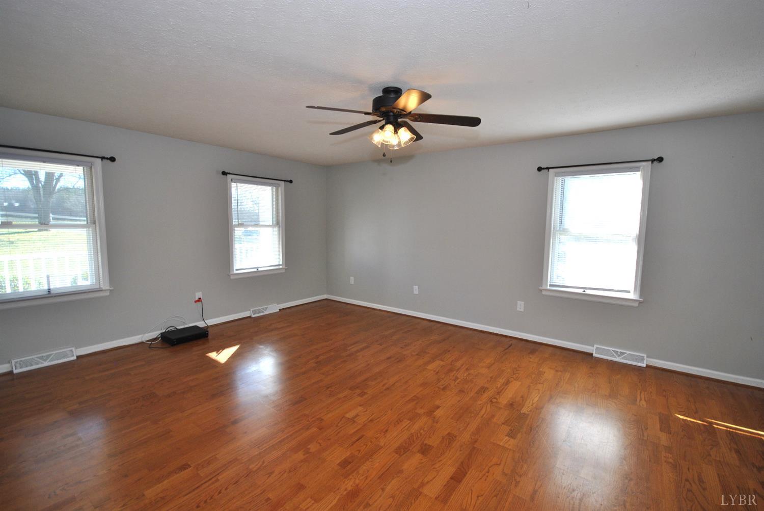 3350 Roaring Run Road Goode, VA 24556 - Photo 40 of 90 a view of an empty room with wooden floor and a window