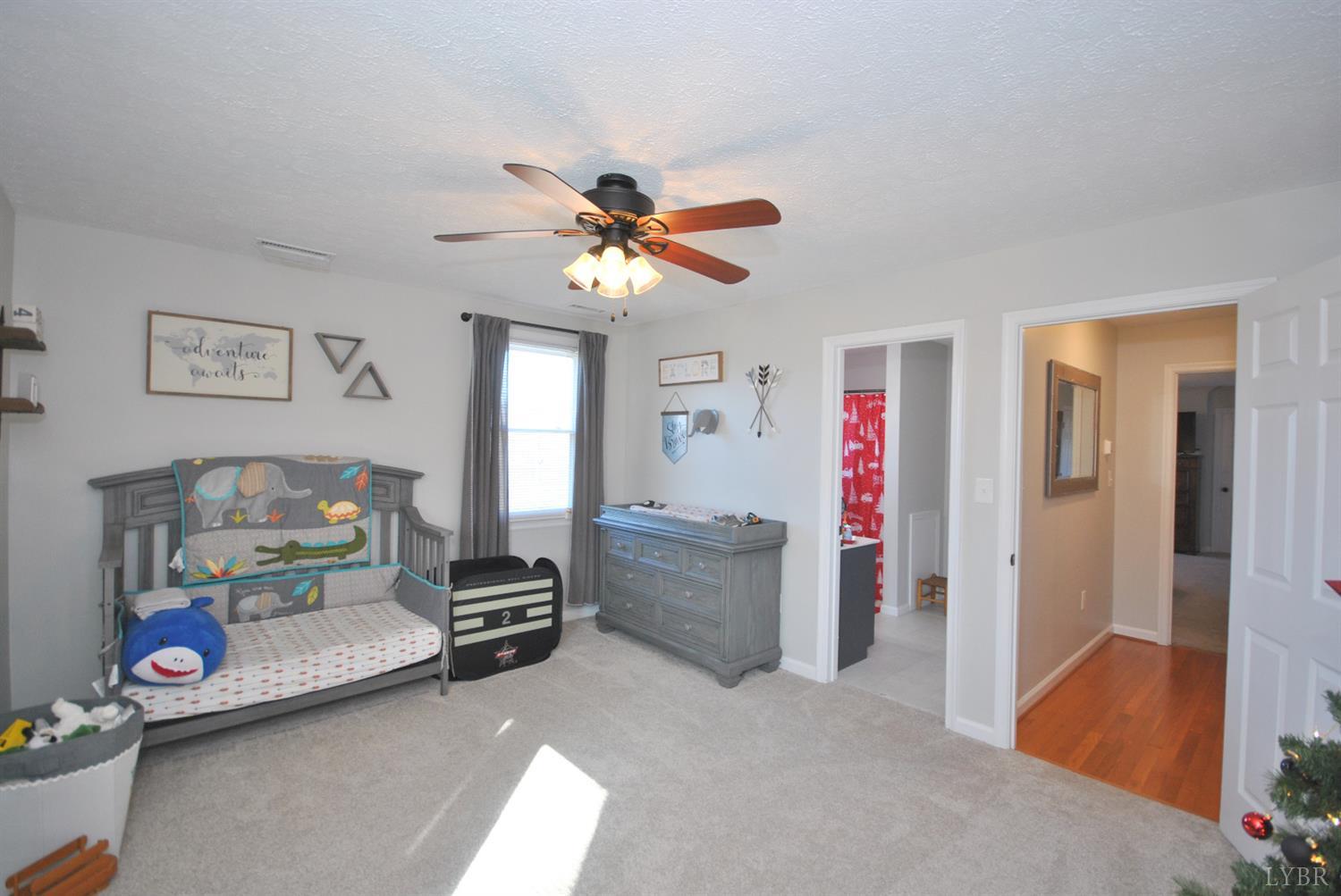 3350 Roaring Run Road Goode, VA 24556 - Photo 48 of 90 a bedroom with furniture and a chandelier