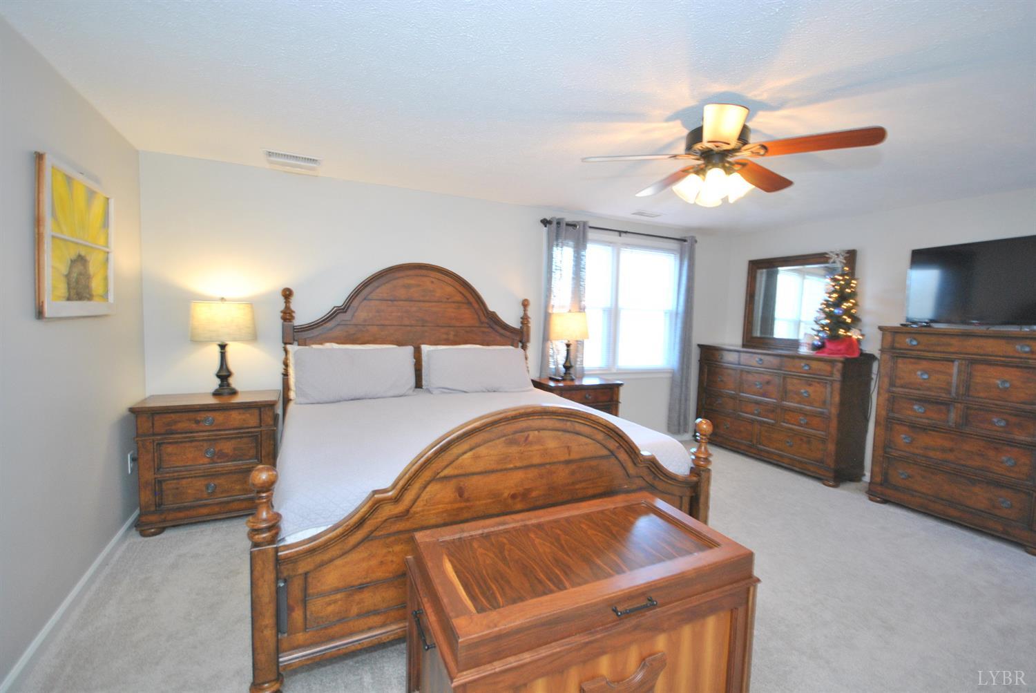 3350 Roaring Run Road Goode, VA 24556 - Photo 51 of 90 a bedroom with a bed and a chandelier