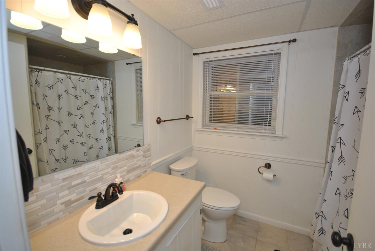 3350 Roaring Run Road Goode, VA 24556 - Photo 63 of 90 a bathroom with a sink and a mirror