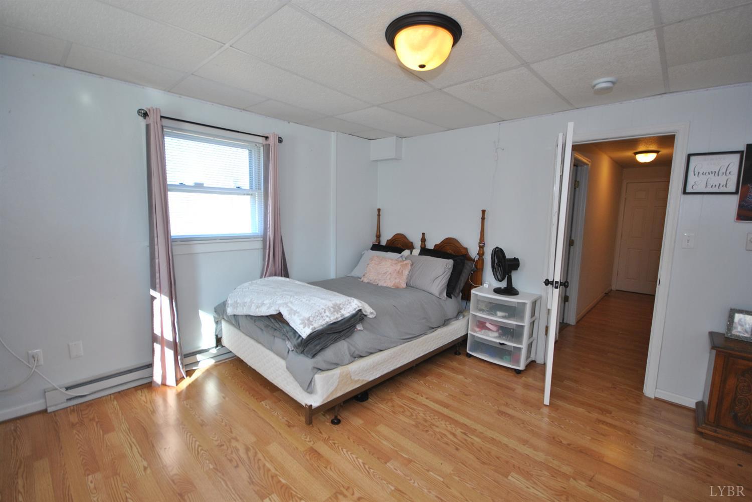 3350 Roaring Run Road Goode, VA 24556 - Photo 66 of 90 a bedroom with a bed and wooden floor