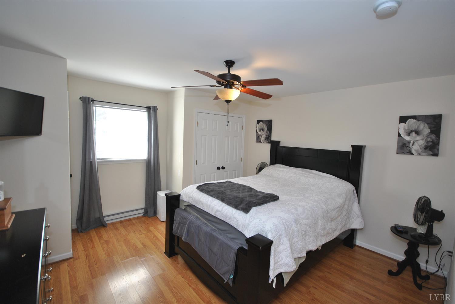 3350 Roaring Run Road Goode, VA 24556 - Photo 67 of 90 a bedroom with a bed and wooden floor