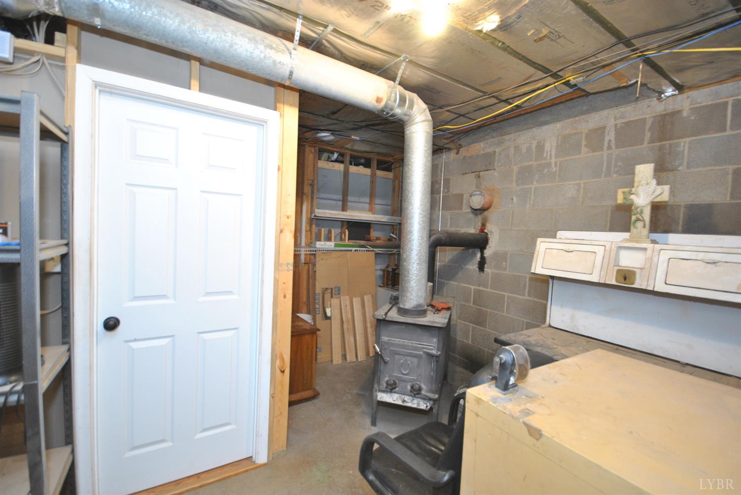 3350 Roaring Run Road Goode, VA 24556 - Photo 72 of 90 a room with wooden furniture and windows