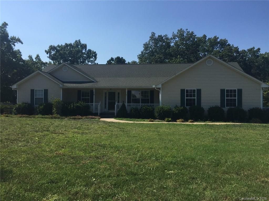 420 Big Level Road Mill Spring, NC 28756 - Photo 1 of 4 a front view of a house with a garden