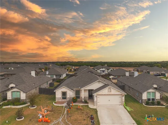an aerial view of residential houses with outdoor space