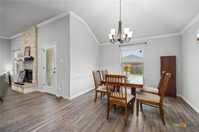 a view of a dining room with furniture wooden floor and a chandelier