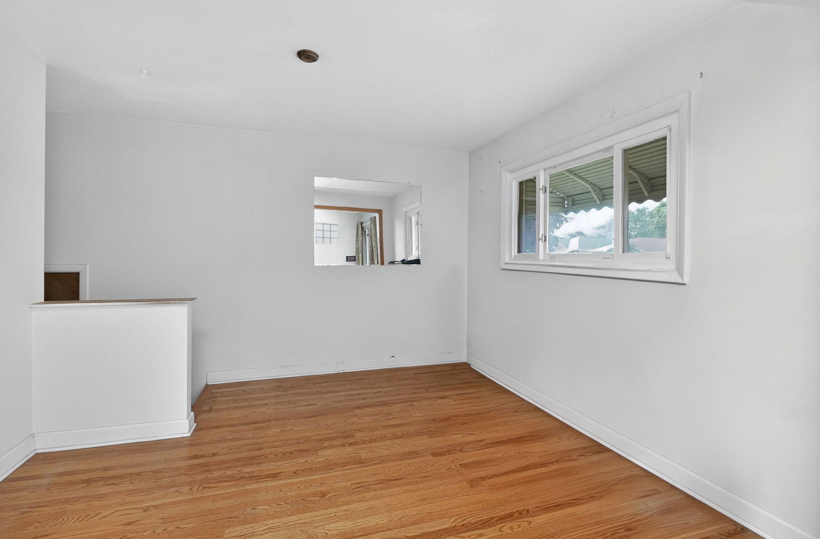 2213 Park Avenue North Riverside, IL 60546 - Photo 5 of 20 a view of an empty room with wooden floor and a window