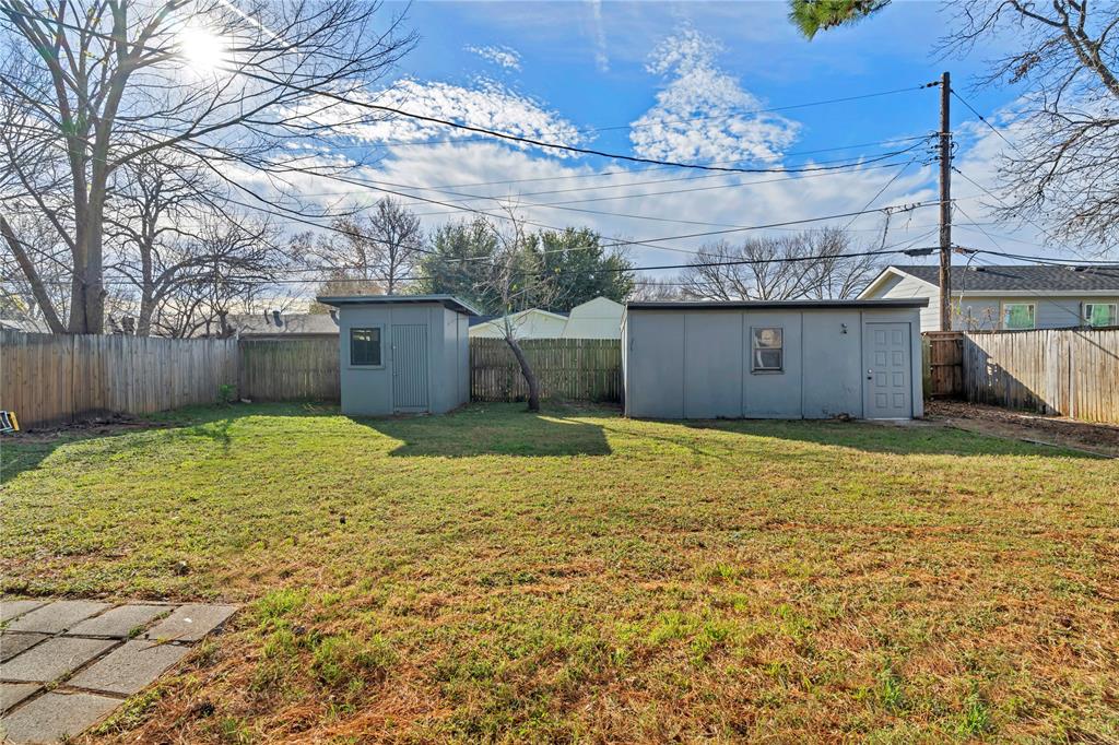 210 Slaughter Street Arlington, TX 76011 - Photo 31 of 33 Fenced backyard featuring a shed