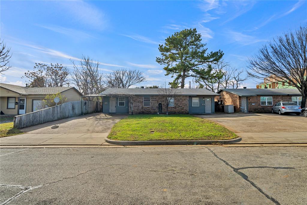 210 Slaughter Street Arlington, TX 76011 - Photo 5 of 33 Ranch-style home featuring a front yard, brick siding, and driveway