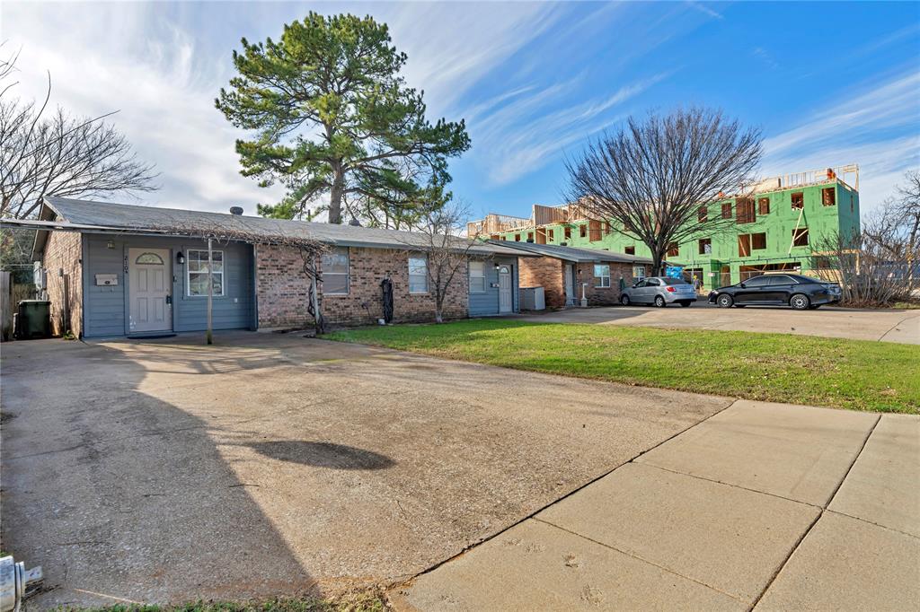 210 Slaughter Street Arlington, TX 76011 - Photo 6 of 33 View of front facade with brick siding and a front yard