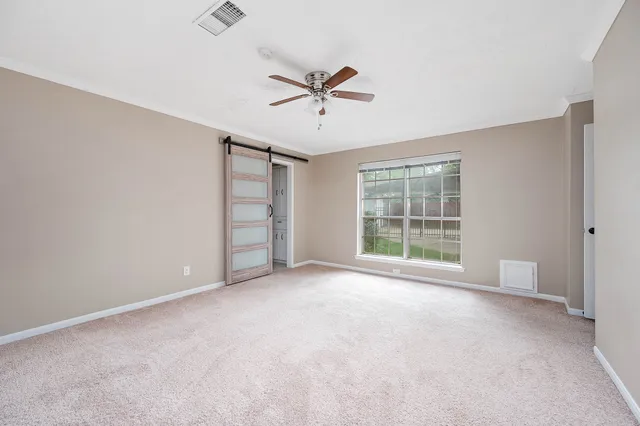 a view of a livingroom with a ceiling fan and window