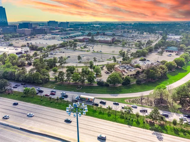 an aerial view of residential houses with outdoor space and street view