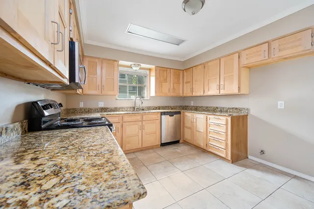 a kitchen with a stove a sink and a refrigerator