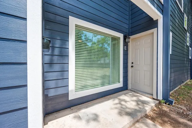 a view of a backyard of a house with a large window