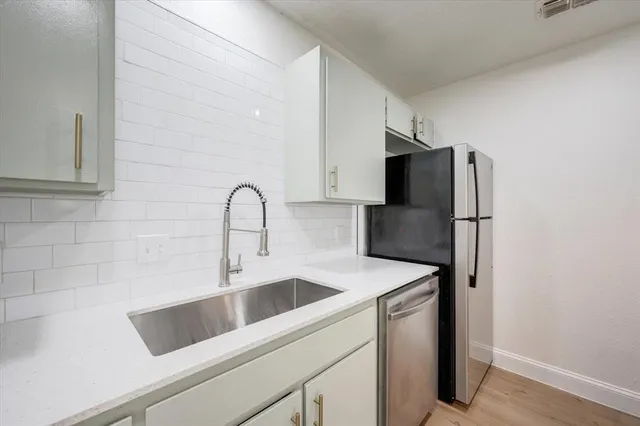 a close view of a sink and refrigerator