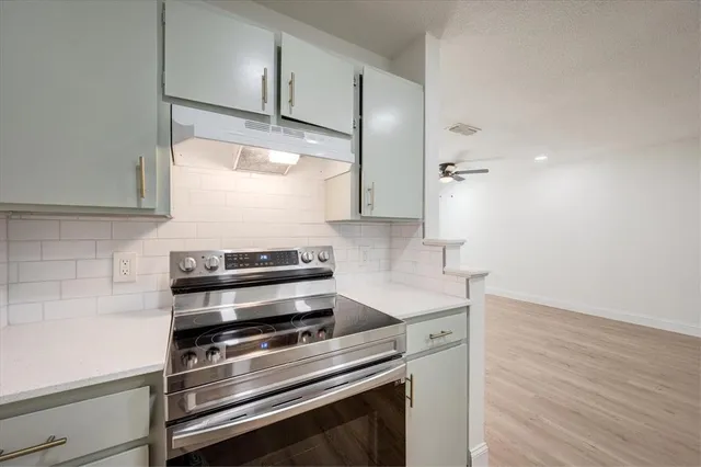 a kitchen with a stove and a microwave