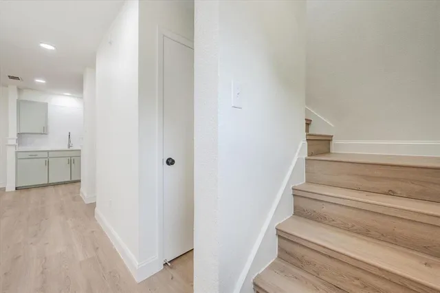 a view of entryway and hall with wooden floor