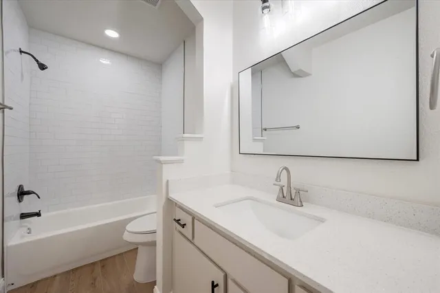 a bathroom with a sink toilet vanity and shower