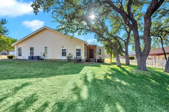 a view of a house with yard and tree s