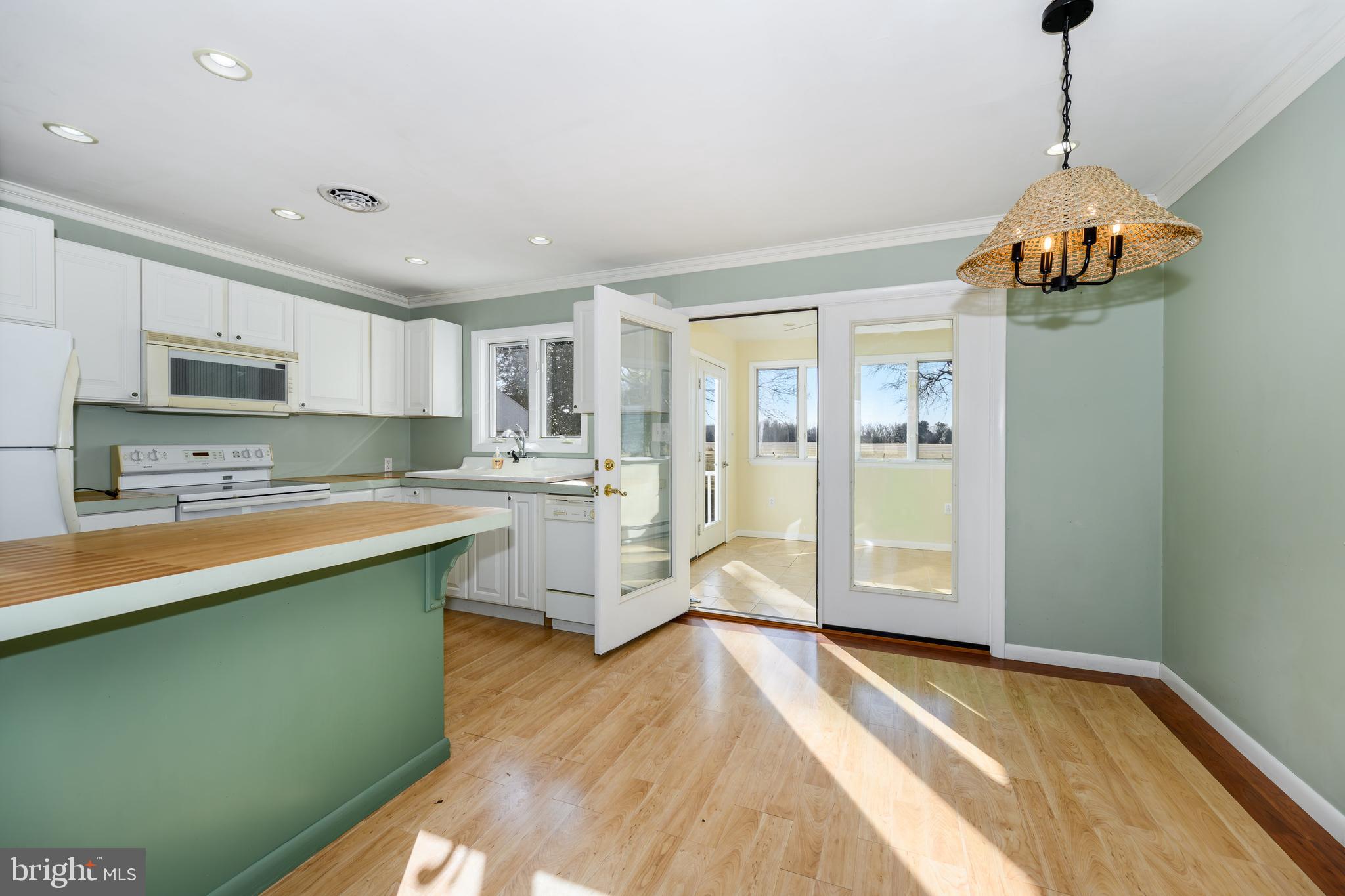 24339 Chestertown Road Chestertown, MD 21620 - Photo 11 of 35 a large kitchen with kitchen island a sink stainless steel appliances and cabinets