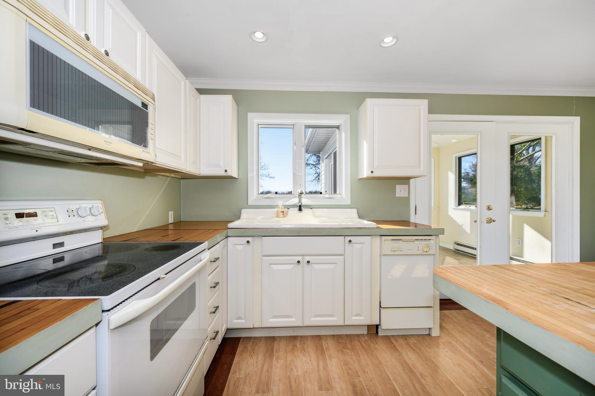 24339 Chestertown Road Chestertown, MD 21620 - Photo 12 of 35 a kitchen with granite countertop white cabinets and white appliances