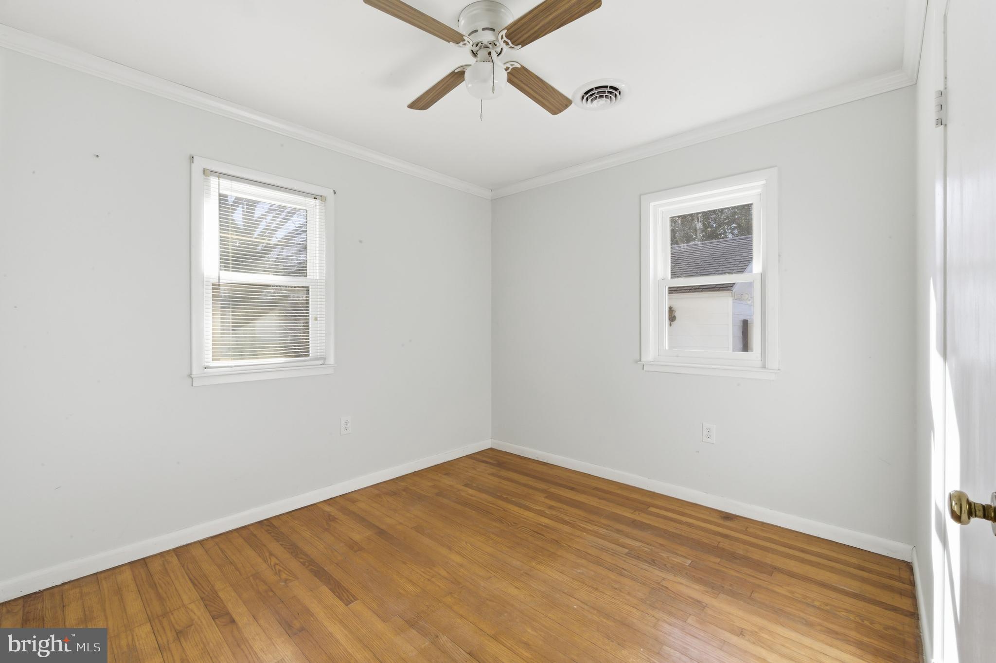 24339 Chestertown Road Chestertown, MD 21620 - Photo 17 of 35 a view of empty room with wooden floor and fan