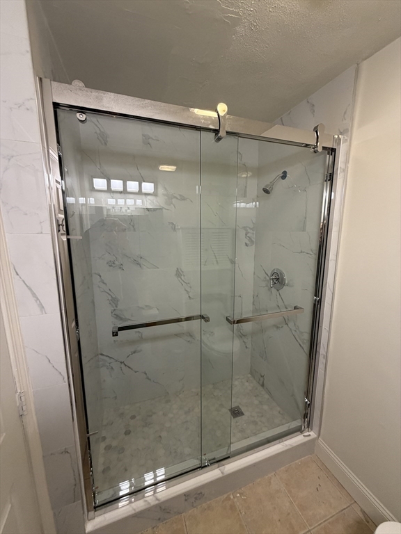 130 West 8th Street, Unit 3 Boston, MA 02127 - Photo 15 of 32 a bathroom with a glass shower door