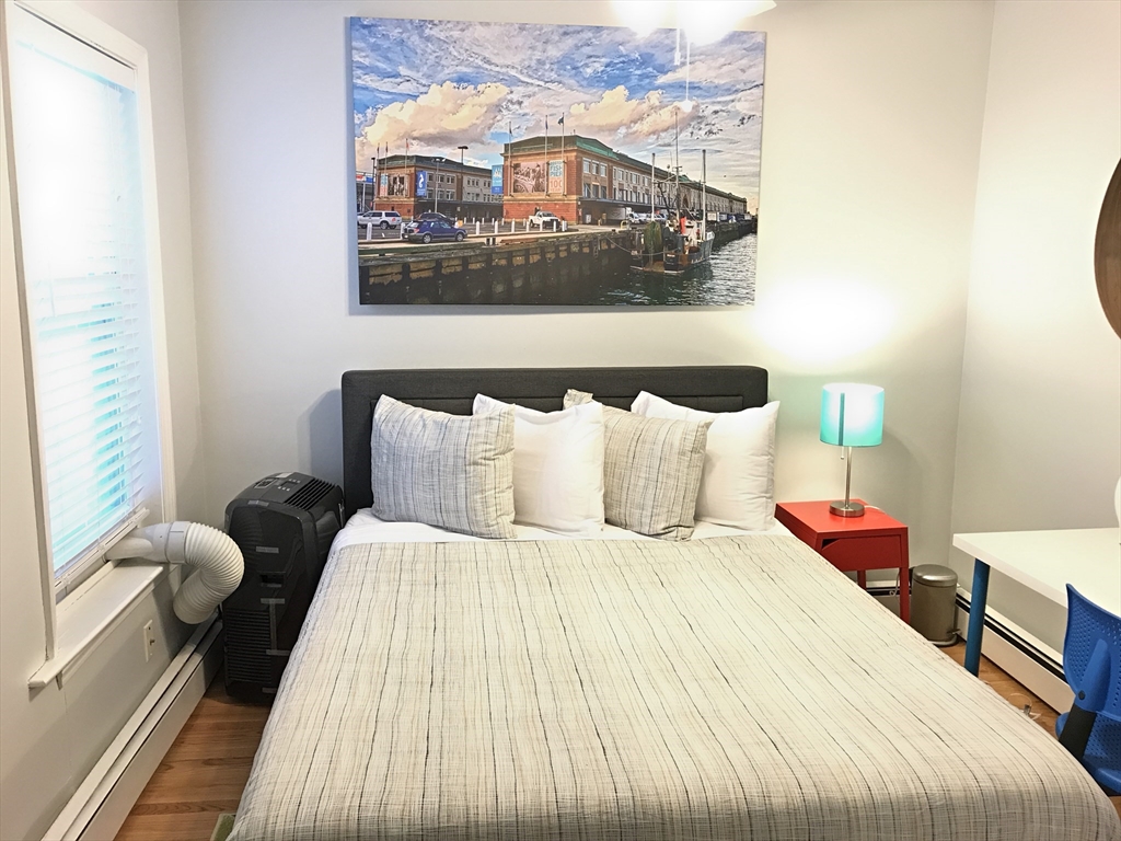 130 West 8th Street, Unit 3 Boston, MA 02127 - Photo 28 of 32 a bedroom with bed and wooden floor