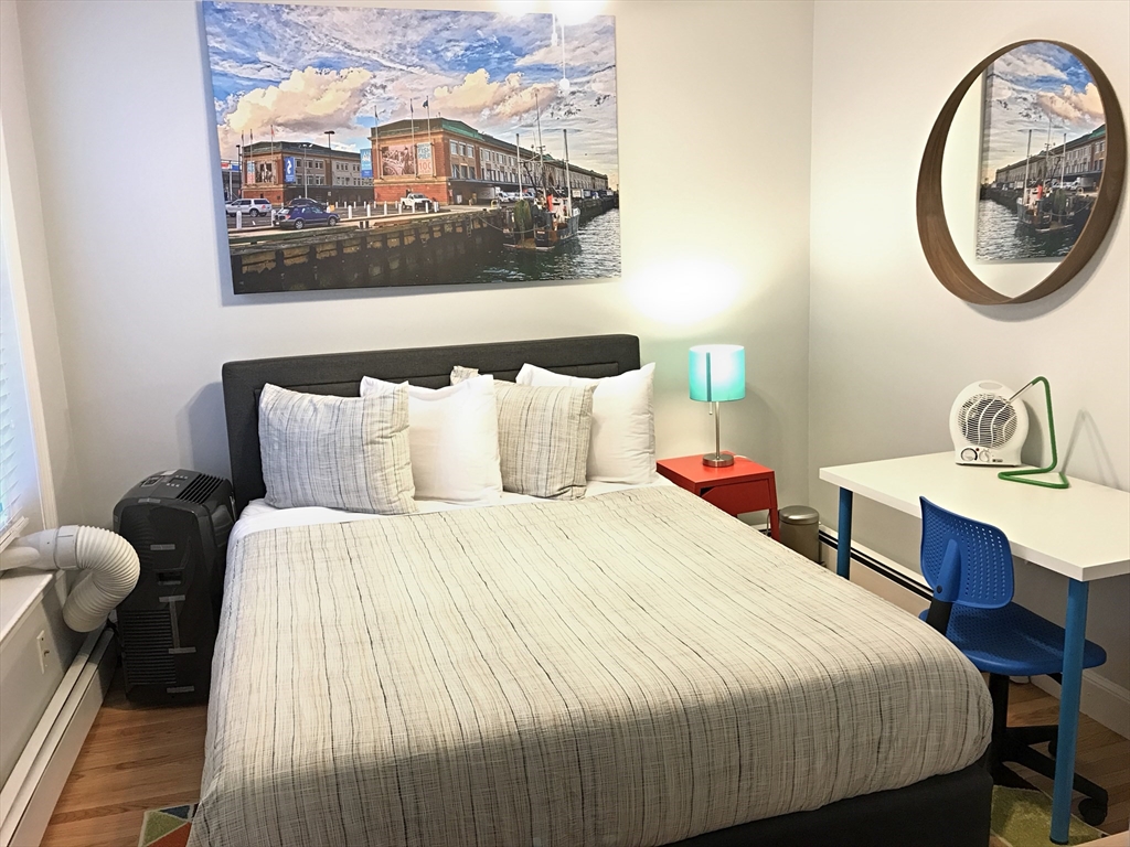 130 West 8th Street, Unit 3 Boston, MA 02127 - Photo 29 of 32 a bedroom with a bed and a painting on the wall