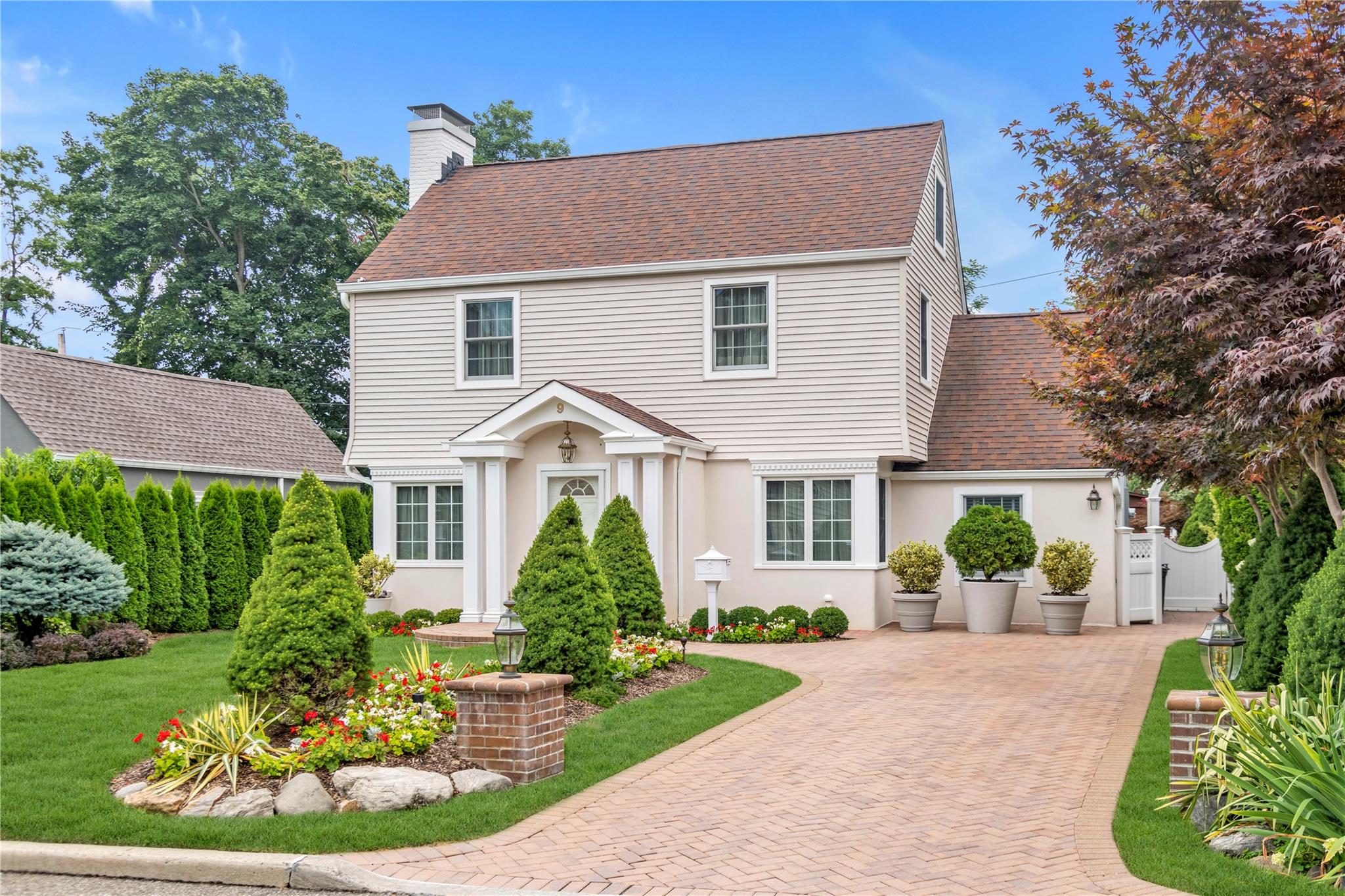 9 Robin Road Manhasset, NY 11030 - Photo 1 of 1 front view of a house with a yard