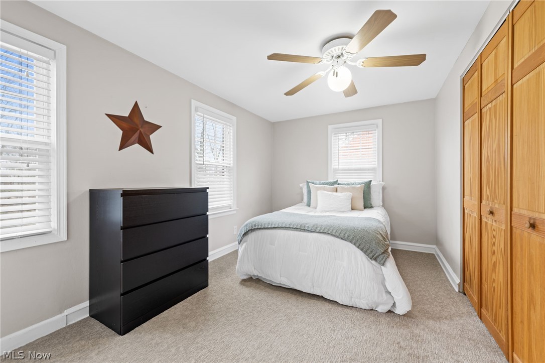 2368 Ashurst Road Cleveland, OH 44118 - Photo 12 of 20 Carpeted bedroom featuring multiple windows, ceiling fan, and a closet