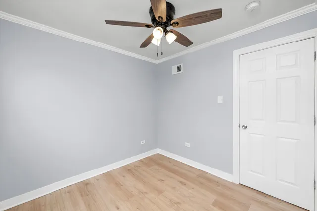 an empty room with a ceiling fan and a window