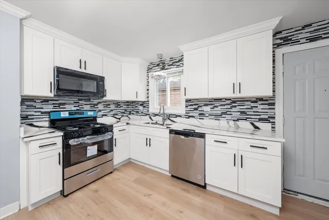 a kitchen with granite countertop cabinets stainless steel appliances and wooden floor
