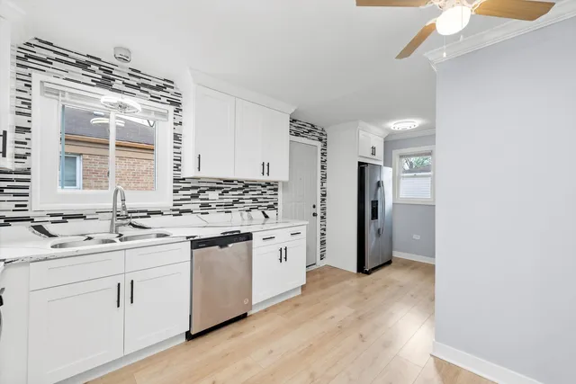 a kitchen with a sink stove and refrigerator